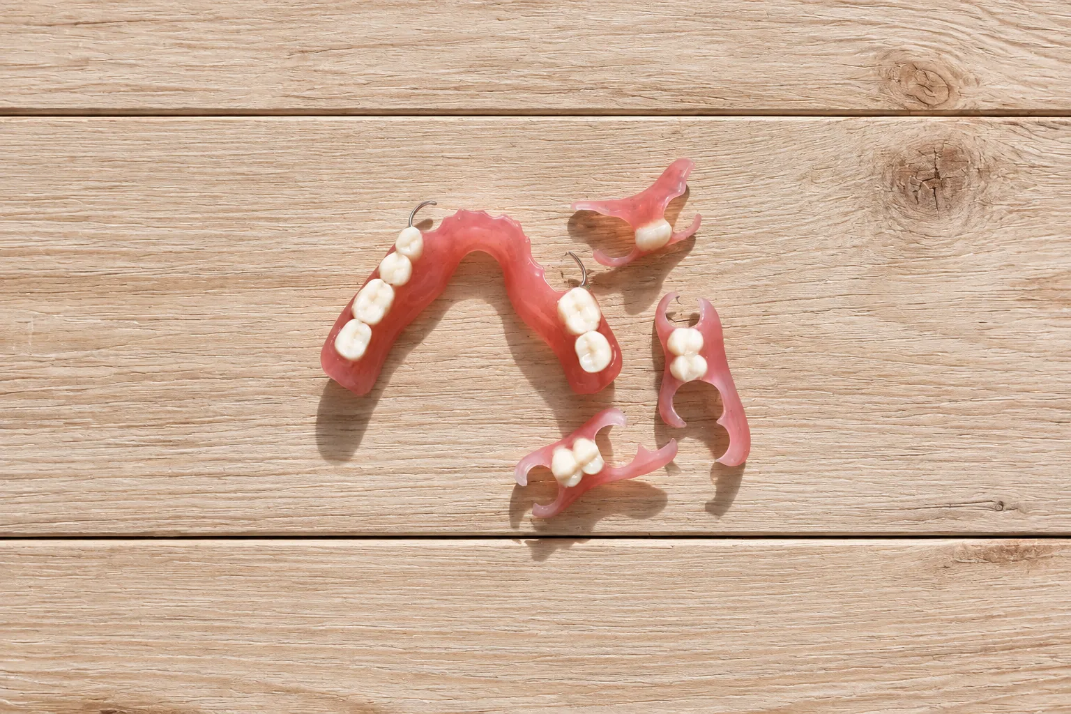 Partial dentures on a wooden surface