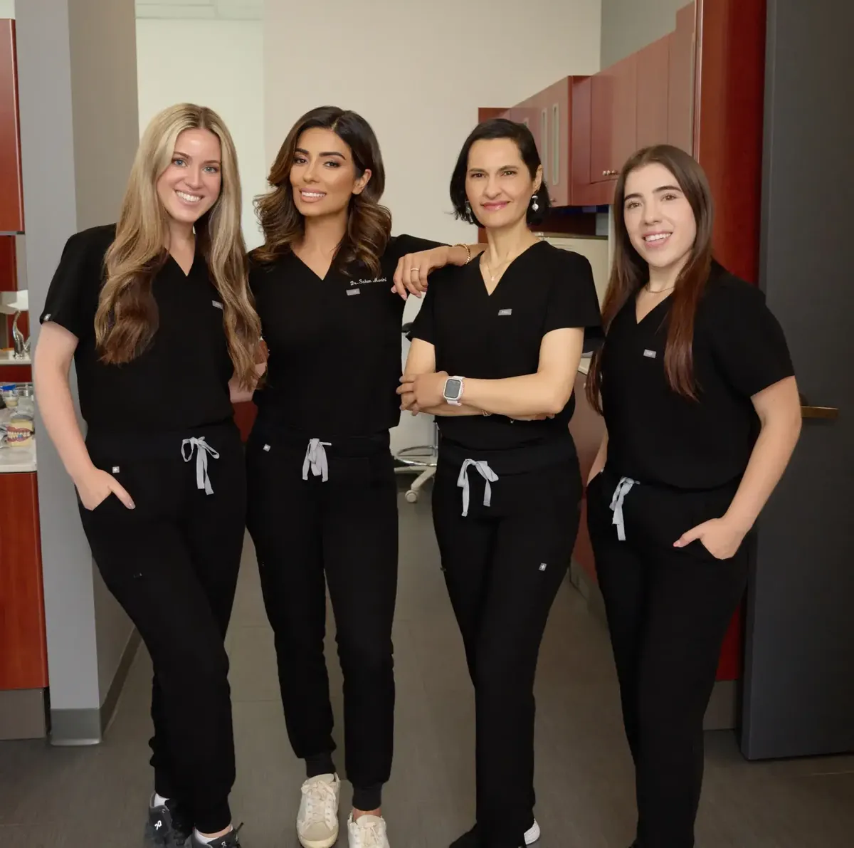 Four members of the Solace Dentistry team in black scrubs